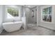 Spa-like bathroom with soaking tub, walk-in shower, and gray tile at 790 Maynard Ln, Summerville, SC 29486