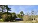 Ranch home with blue trim, situated on a spacious lot with mature trees at 8146 N Highway 17, McClellanville, SC 29458