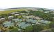 Aerial view of tennis courts near houses and waterway at 102 High Hammock Villas, Seabrook Island, SC 29455