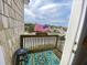 Small balcony with ocean view, American flag, and rug at 108 Palmetto Blvd, Edisto Beach, SC 29438
