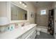 Bathroom with tiled tub/shower, white vanity, and decorative mermaid window at 108 Palmetto Blvd, Edisto Beach, SC 29438