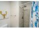 Modern bathroom featuring walk-in shower with gray tile and lobster artwork at 108 Palmetto Blvd, Edisto Beach, SC 29438
