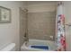 Clean bathroom with tiled shower/tub combo and floral shower curtain at 108 Palmetto Blvd, Edisto Beach, SC 29438