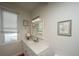 Bright bathroom with white vanity, ocean view, and decorative coastal artwork at 108 Palmetto Blvd, Edisto Beach, SC 29438