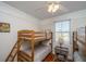Cozy bedroom with two wooden bunk beds and a window at 108 Palmetto Blvd, Edisto Beach, SC 29438