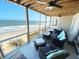 Covered deck overlooking the beach with outdoor seating at 108 Palmetto Blvd, Edisto Beach, SC 29438