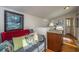 Living area with a comfortable couch and kitchenette, perfect for relaxation at 108 Palmetto Blvd, Edisto Beach, SC 29438