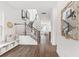 Bright and airy entryway with hardwood floors, built-in bench, and staircase at 1447 Clay Field Trl, Summerville, SC 29485