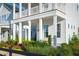 Charming front porch with a porch swing, surrounded by lush landscaping at 1447 Clay Field Trl, Summerville, SC 29485