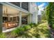 Relaxing backyard patio with porch swing, grill, and lush landscaping at 2220 Ion Ave, Sullivans Island, SC 29482
