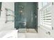 Modern bathroom with a walk-in shower and stylish blue tile at 2220 Ion Ave, Sullivans Island, SC 29482