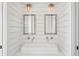 Bathroom with a double vanity and stylish industrial lighting at 2220 Ion Ave, Sullivans Island, SC 29482