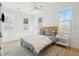 Bright bedroom with white shiplap walls, a comfortable bed, and a window with plantation shutters at 2220 Ion Ave, Sullivans Island, SC 29482