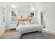 Light and airy bedroom with white shiplap walls and a walk-in closet at 2220 Ion Ave, Sullivans Island, SC 29482