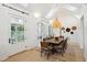 Bright dining room with long wooden table and woven chairs at 2220 Ion Ave, Sullivans Island, SC 29482