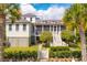 Charming two-story home with a metal roof, screened porch, and landscaped yard at 2220 Ion Ave, Sullivans Island, SC 29482
