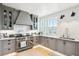 Gray kitchen features stainless steel appliances and white subway tile backsplash at 2220 Ion Ave, Sullivans Island, SC 29482