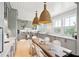 Gray kitchen with island, stainless steel appliances, and white quartz countertops at 2220 Ion Ave, Sullivans Island, SC 29482