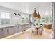 Open kitchen with gray cabinets and a farmhouse dining table at 2220 Ion Ave, Sullivans Island, SC 29482