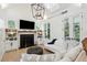 Living room with fireplace, built-in shelving and hardwood floors at 2220 Ion Ave, Sullivans Island, SC 29482