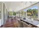 Relaxing screened porch with wicker furniture and dining area at 2220 Ion Ave, Sullivans Island, SC 29482
