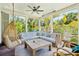 Cozy screened porch with hanging chair and sectional sofa at 2220 Ion Ave, Sullivans Island, SC 29482