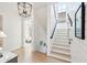 Elegant staircase with white shiplap walls and a rope railing at 2220 Ion Ave, Sullivans Island, SC 29482