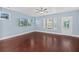 Spacious living room with hardwood floors, large windows, and a mounted TV at 313 Oakbend St, Summerville, SC 29486