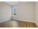 Simple bedroom with wood-look flooring and a window with a view at 316 Trailmore Ln, Summerville, SC 29486