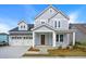 Two-story house with gray siding, white trim, and a three-car garage at 316 Trailmore Ln, Summerville, SC 29486