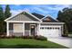Gray farmhouse exterior with white trim, two-car garage, and covered porch at 319 Calm Water Way, Summerville, SC 29486