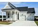 Two-car garage and front porch, light grey siding, and a dark grey roof at 346 Trailmore Ln, Summerville, SC 29486
