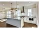 Island kitchen with white cabinets, granite, and pendant lights at 346 Trailmore Ln, Summerville, SC 29486