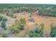 Aerial view of home on large lot with mature trees and expansive landscape at 388 E Main St, Harleyville, SC 29448