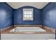 Bathroom with soaking tub and blue walls at 388 E Main St, Harleyville, SC 29448