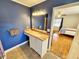 Bathroom with blue walls, granite vanity, and a walk-in shower at 388 E Main St, Harleyville, SC 29448