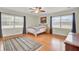 Charming bedroom with hardwood floors, window seating and area rug at 388 E Main St, Harleyville, SC 29448