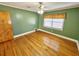 Charming bedroom with hardwood floors and green walls at 388 E Main St, Harleyville, SC 29448