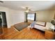 Bright bedroom featuring hardwood floors, ceiling fan, and large windows at 388 E Main St, Harleyville, SC 29448