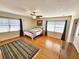 Spacious bedroom with hardwood floors, ceiling fan, and ample natural light at 388 E Main St, Harleyville, SC 29448