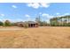 Brick home with covered porch and large yard at 388 E Main St, Harleyville, SC 29448