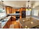 Bright kitchen featuring granite countertops, ample cabinetry, and a center island at 388 E Main St, Harleyville, SC 29448