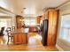 Spacious kitchen with granite countertops, wood cabinets, and stainless steel appliances at 388 E Main St, Harleyville, SC 29448