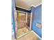 Clean shower with glass enclosure and neutral tile at 388 E Main St, Harleyville, SC 29448