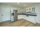 Basement kitchen with white cabinets, stainless steel appliances, and blue countertops at 738 Olney Rd, Charleston, SC 29414