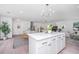 White kitchen island with quartz countertop, seating, and ample storage at 738 Olney Rd, Charleston, SC 29414