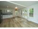Kitchen features white cabinets, stainless steel appliances, and a view to backyard at 738 Olney Rd, Charleston, SC 29414