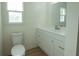 Clean bathroom with white vanity, toilet and a window for natural light at 106 Reardon Ave, Walterboro, SC 29488