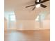 Spacious bonus room featuring wood floors, two windows, and a ceiling fan at 106 Reardon Ave, Walterboro, SC 29488