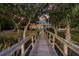 Charming wooden bridge leading to a waterfront home at sunset at 122 Cainhoy Landing Rd, Charleston, SC 29492